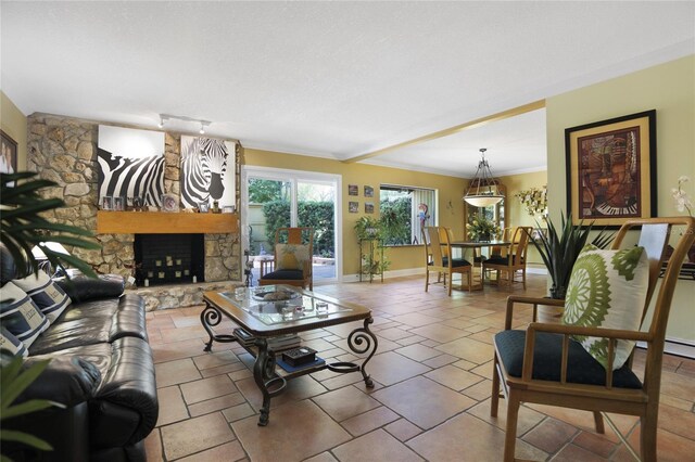 living room with ornamental molding, tile patterned flooring, and a stone fireplace