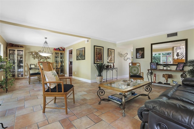 living room featuring baseboards, visible vents, stone tile flooring, and ornamental molding