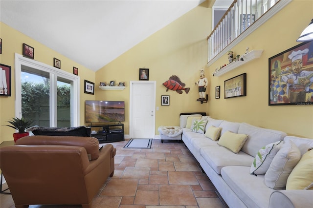 living room with high vaulted ceiling and baseboards