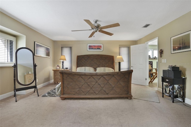 bedroom featuring light carpet, baseboards, visible vents, and ceiling fan