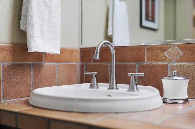 interior details featuring decorative backsplash and a sink