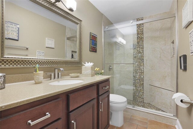 bathroom with an enclosed shower, tile patterned flooring, toilet, and vanity