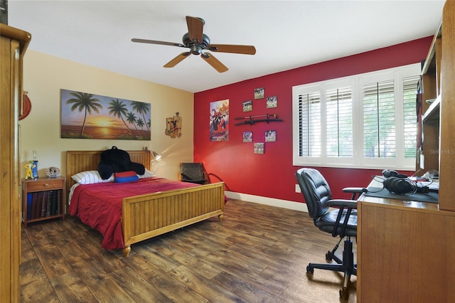 bedroom featuring a ceiling fan, baseboards, and wood finished floors