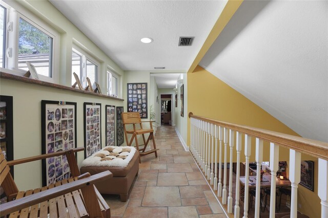 corridor featuring a textured ceiling