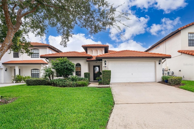 mediterranean / spanish house featuring a garage and a front yard