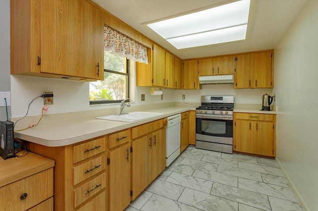 kitchen featuring sink, white dishwasher, and stainless steel gas range