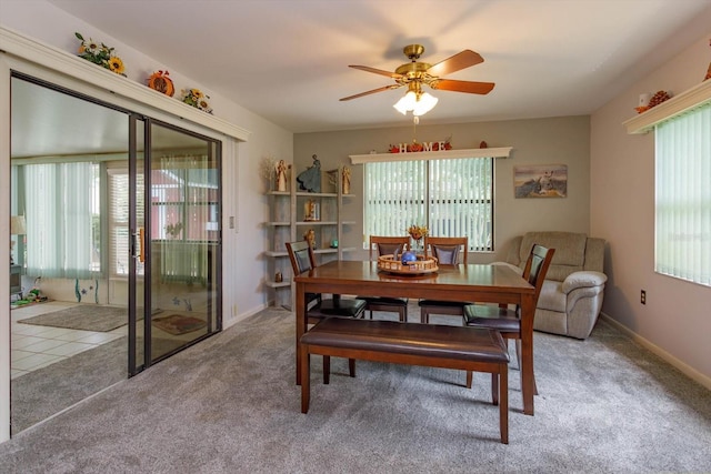 dining space featuring light colored carpet, a wealth of natural light, and ceiling fan