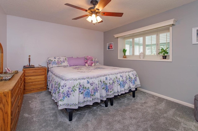 carpeted bedroom featuring ceiling fan and a textured ceiling