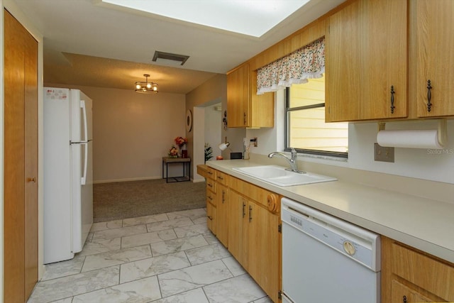 kitchen featuring light carpet, sink, hanging light fixtures, and white appliances