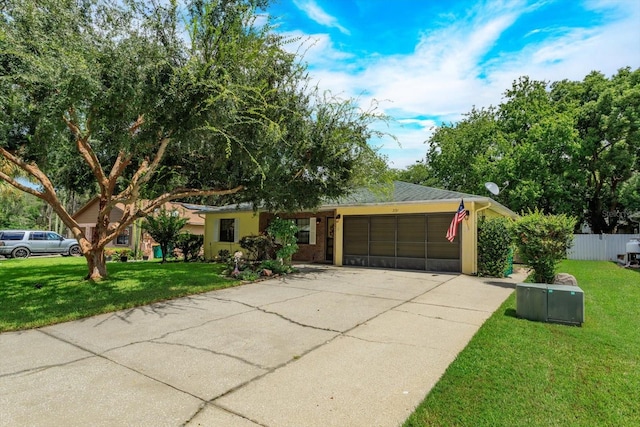 single story home with a front yard and a garage