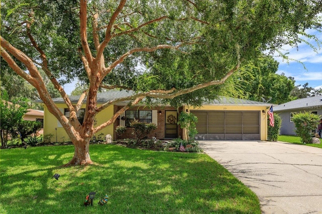 single story home with a garage and a front lawn