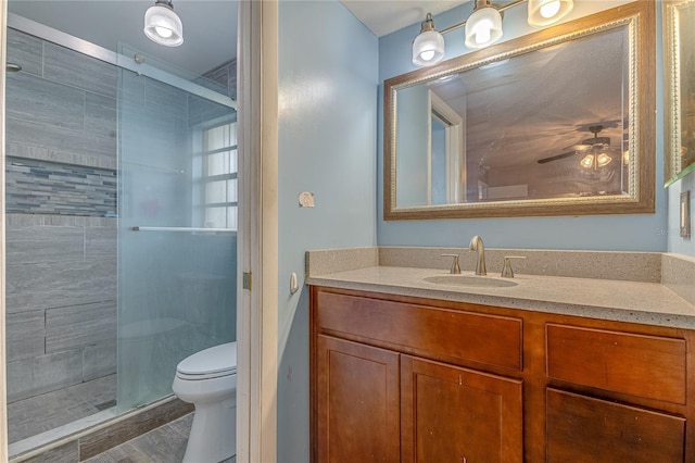 bathroom featuring walk in shower, vanity, and toilet
