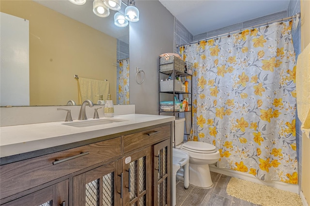 full bathroom with shower / bath combination with curtain, vanity, hardwood / wood-style floors, and toilet
