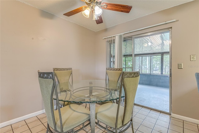 tiled dining room featuring a textured ceiling and ceiling fan