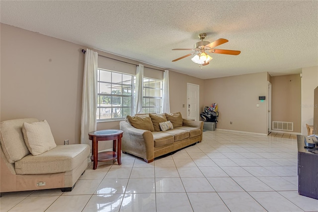 tiled living room featuring a textured ceiling and ceiling fan