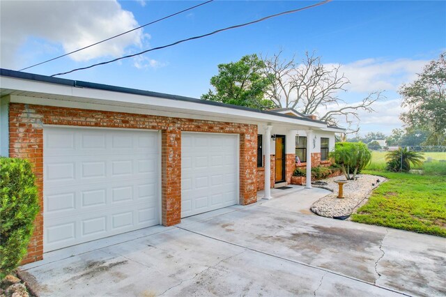 view of front of home with a garage and a front lawn