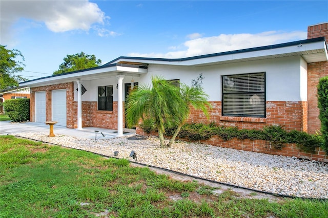 view of front of property with a garage, a front yard, and a porch