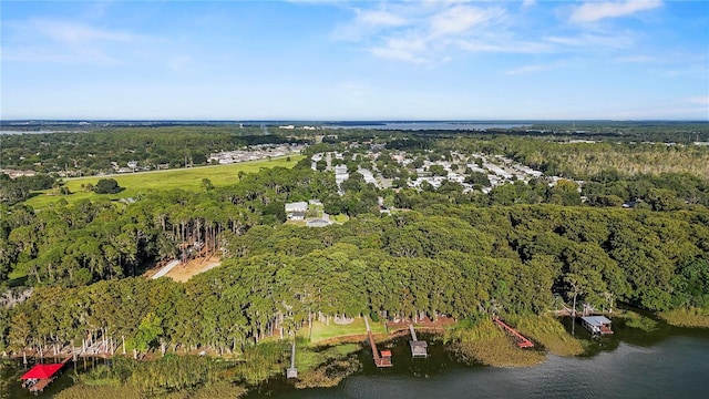 aerial view with a water view and a forest view