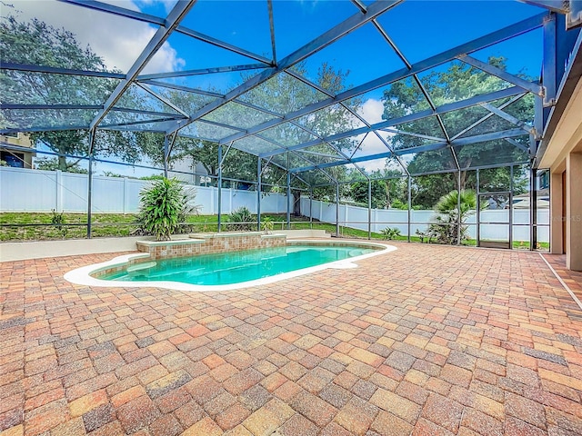 view of swimming pool featuring a patio area and glass enclosure