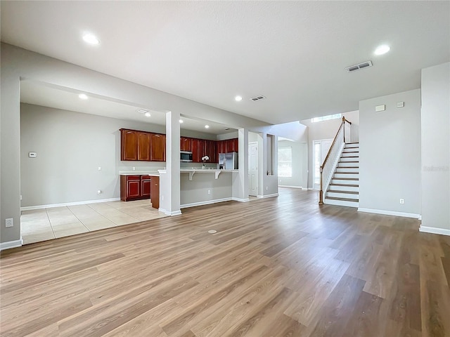 unfurnished living room with light hardwood / wood-style flooring