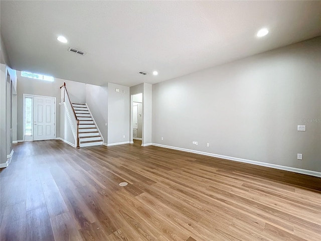 unfurnished living room featuring hardwood / wood-style flooring