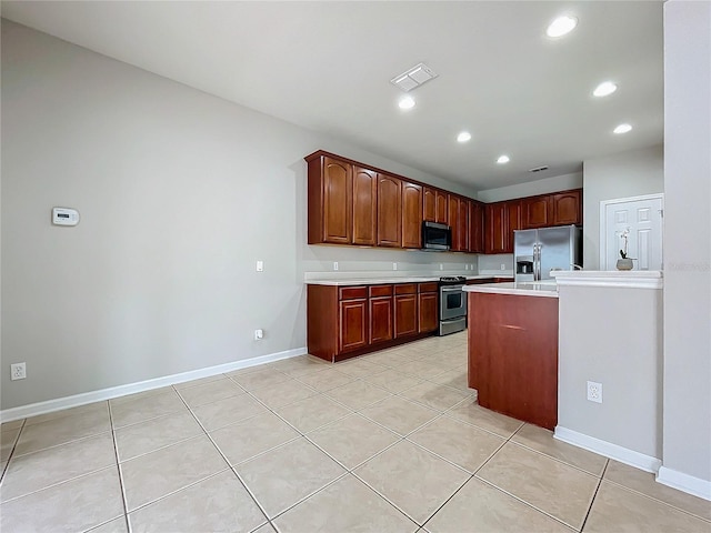 kitchen featuring light tile patterned floors and stainless steel appliances