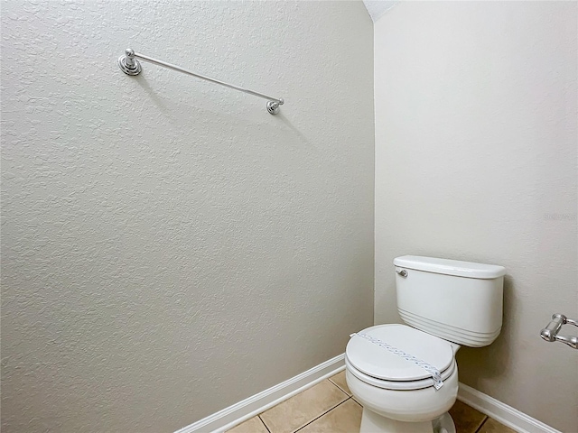 bathroom with toilet and tile patterned floors