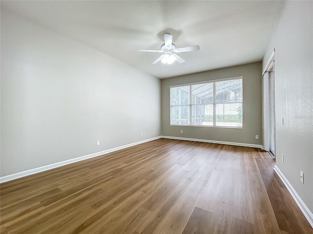 empty room featuring ceiling fan and hardwood / wood-style flooring