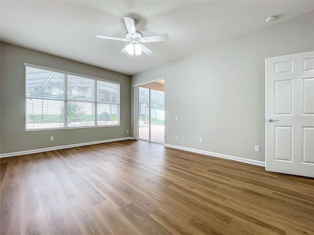 empty room featuring ceiling fan and hardwood / wood-style floors