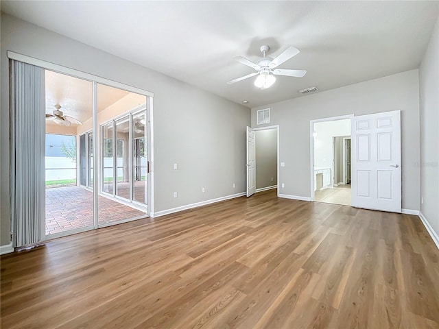 interior space with light wood-type flooring, access to outside, and ceiling fan