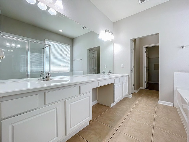 bathroom featuring tile patterned flooring, independent shower and bath, and vanity