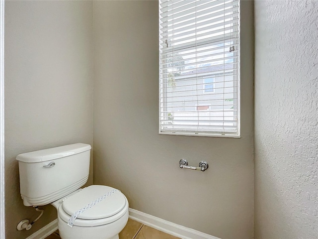 bathroom featuring toilet and tile patterned floors