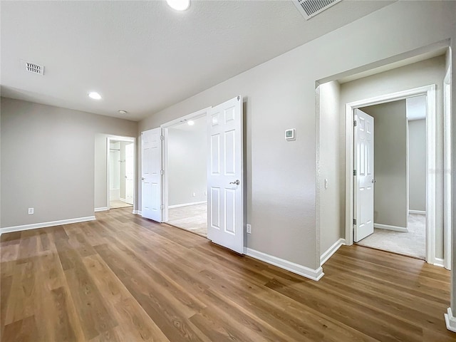 unfurnished room with hardwood / wood-style flooring