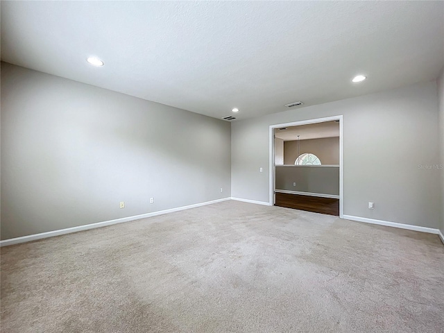 empty room with carpet and a textured ceiling