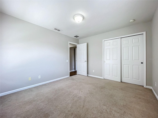 unfurnished bedroom featuring a closet and carpet floors