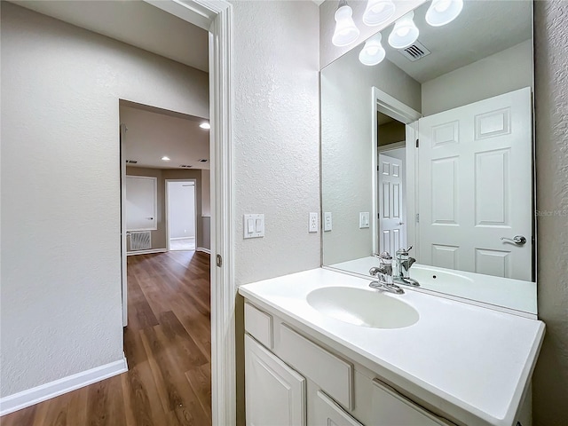 bathroom with hardwood / wood-style floors and vanity