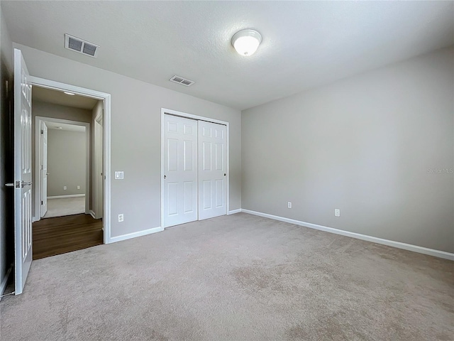 unfurnished bedroom with carpet flooring and a closet