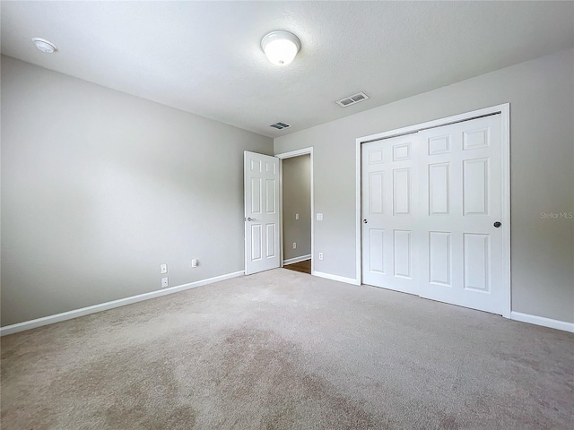 unfurnished bedroom featuring a closet and carpet flooring