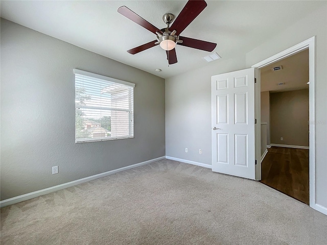 interior space with ceiling fan and light carpet