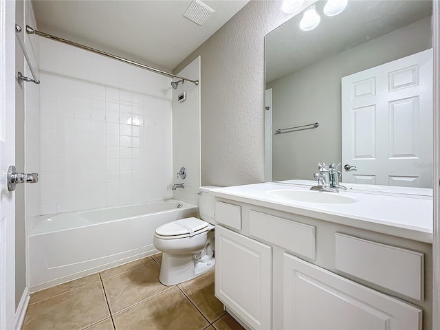 full bathroom featuring vanity, toilet, tiled shower / bath combo, and tile patterned floors