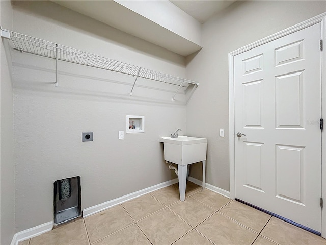 laundry room with hookup for a washing machine, light tile patterned floors, and electric dryer hookup