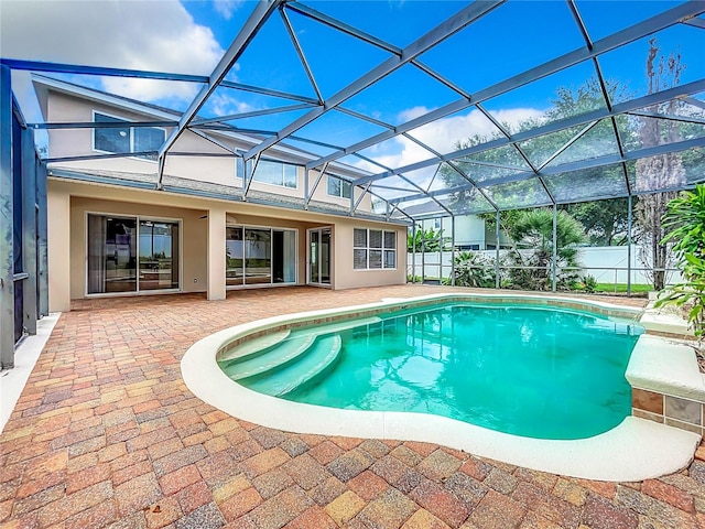 view of swimming pool with a lanai and a patio area