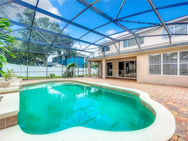 view of swimming pool with a patio and a lanai