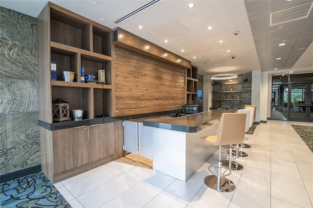 kitchen featuring a breakfast bar area and light tile patterned floors