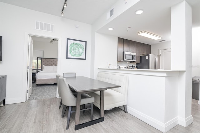 dining space with light hardwood / wood-style floors