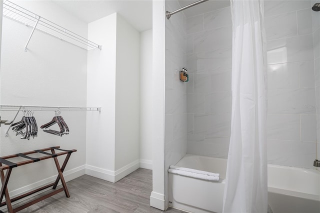 bathroom with shower / tub combo and hardwood / wood-style flooring