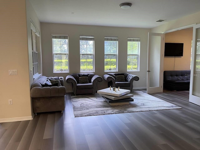 living area with visible vents, french doors, baseboards, and dark wood-style flooring