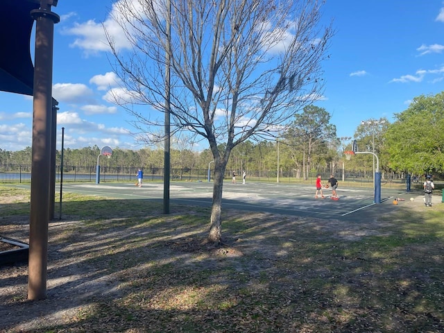 view of property's community featuring community basketball court and fence