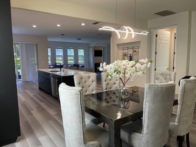 dining area featuring recessed lighting, visible vents, and light wood finished floors