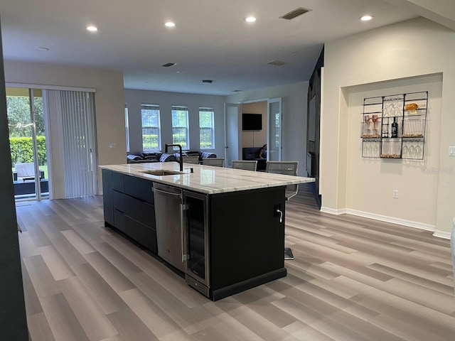 kitchen with visible vents, a center island with sink, dishwasher, recessed lighting, and dark cabinets